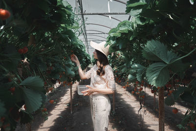 Woman standing by plants