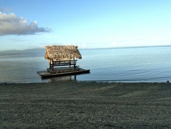 View of calm beach against blue sky