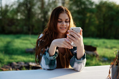 Young woman using mobile phone