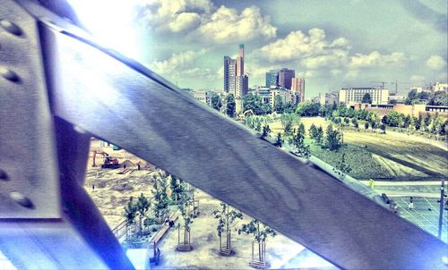 Buildings in city against cloudy sky