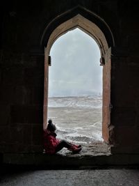 Woman looking at sea against sky