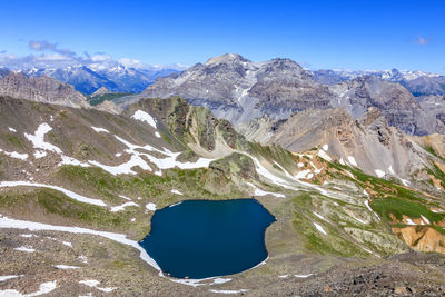 Scenic view of snowcapped mountain against blue sky