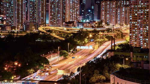 High angle view of illuminated city street and buildings at night