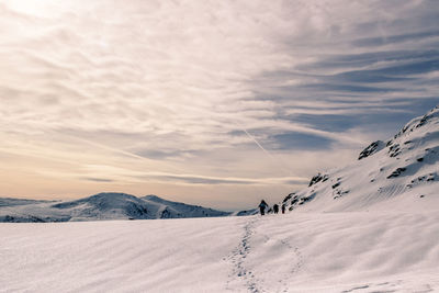 Scenic view of snow landscape against sky during sunset