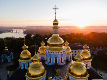 Traditional building against sky during sunset