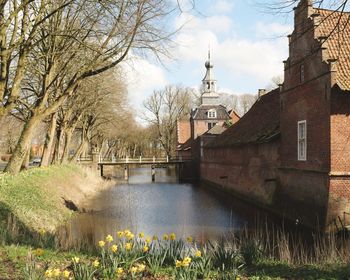 Bridge over river amidst buildings against sky