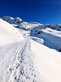 Scenic view of snowcapped mountains against clear sky