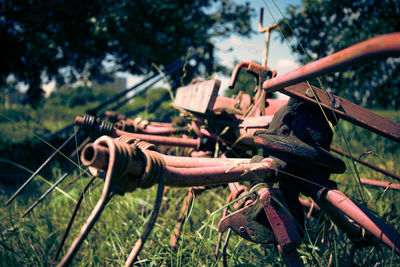 Close-up of rusty machine part on field