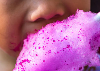 Cropped image of kid eating cotton candy