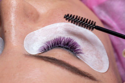 Close-up of woman applying eyeliner