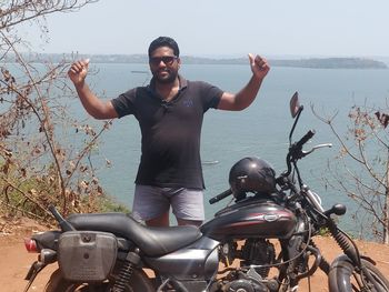 Full length of young man riding motorcycle in water