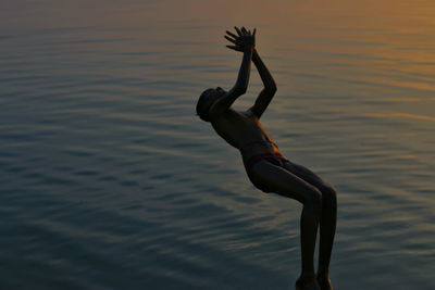 Rear view of a man in water