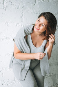 Beautiful happy emotional brunette young woman plus size body positive in comfortable sport wear 
