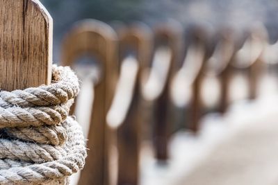 Close-up of rope tied to wooden post