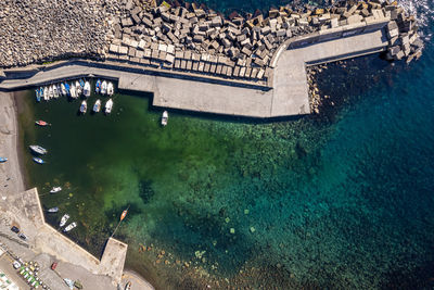 Aerial shot with drone of a small port on the sicilian coast of acireale. italy