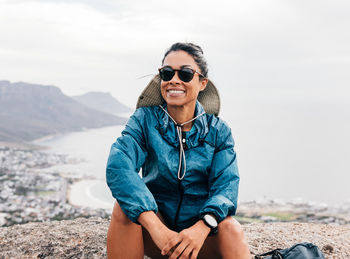 Portrait of woman sitting on rock