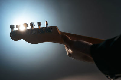 Midsection of person playing guitar