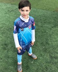 Portrait of boy standing on field