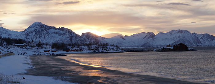 Scenic view of snowcapped mountains against sky during sunset