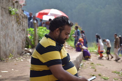 Rear view of a man with umbrella