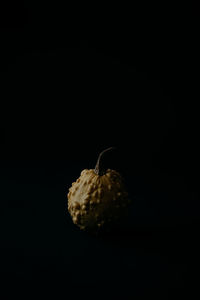 Close-up of fruit on table against black background