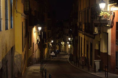 Street amidst illuminated city at night