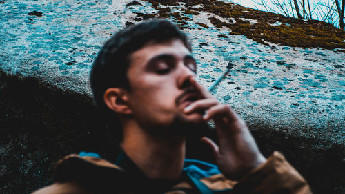 Close-up of young man holding water