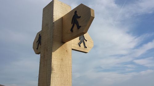 Low angle view of road sign against sky