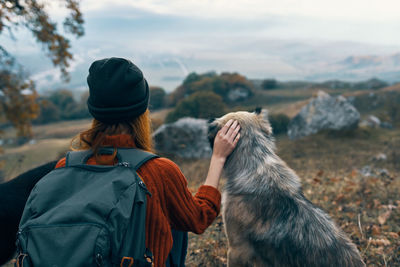 Rear view of man with dog on mountain