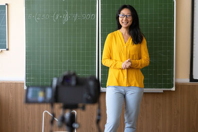 Portrait of young woman teacher doing online lessen in class room