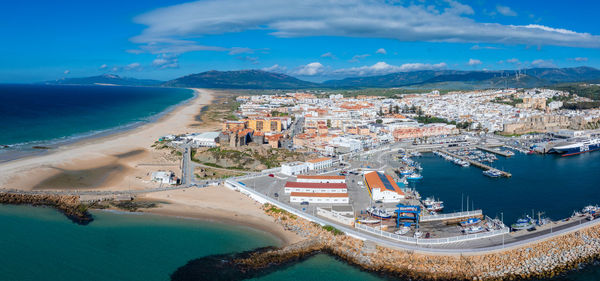 High angle view of townscape by sea against sky
