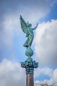 Low angle view of statue against cloudy sky