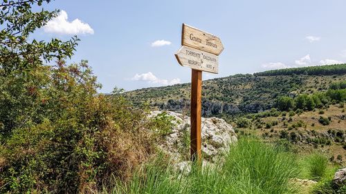 Information sign on landscape against sky