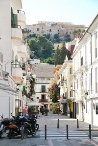 Street amidst buildings in city against sky