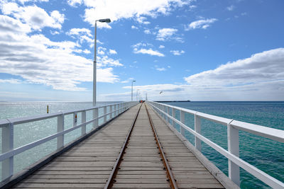 Pier over sea against sky