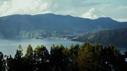 Scenic view of lake and mountains against sky