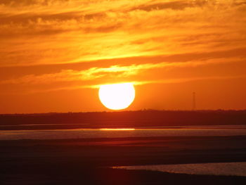 Scenic view of sea against romantic sky at sunset