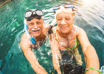 Senior couple snorkeling in sea