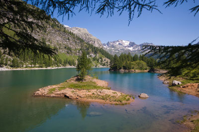 View of little island in the idyllic lake of dévero in piedmont, italy