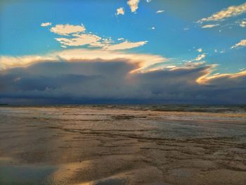 View of calm sea against cloudy sky