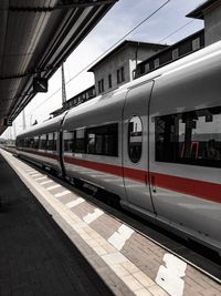 Train at railroad station against sky