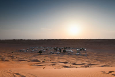 Scenic view of desert against sky during sunset