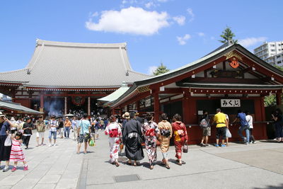 People at temple against sky