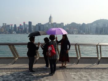 Full length rear view of people in front of building
