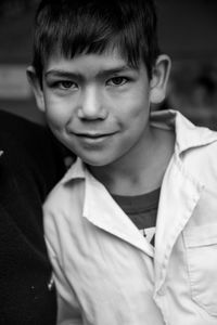 Portrait of smiling boy standing at home