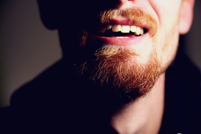 Cropped image of smiling bearded young man