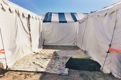 Tents and fabric against blue sky