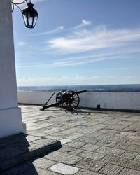 Bicycles on beach against sky