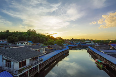 High angle view of swimming pool by building against sky