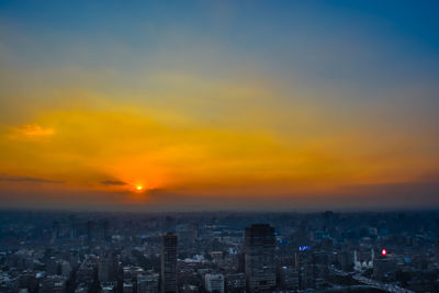 High angle view of buildings against sky during sunset